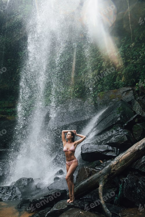 Preview: Gorgeous wet woman posing beside mighty Phnom Kulen waterfall