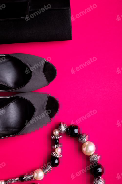 Preview: Black Clutch, Heels and Necklace on Pink Background