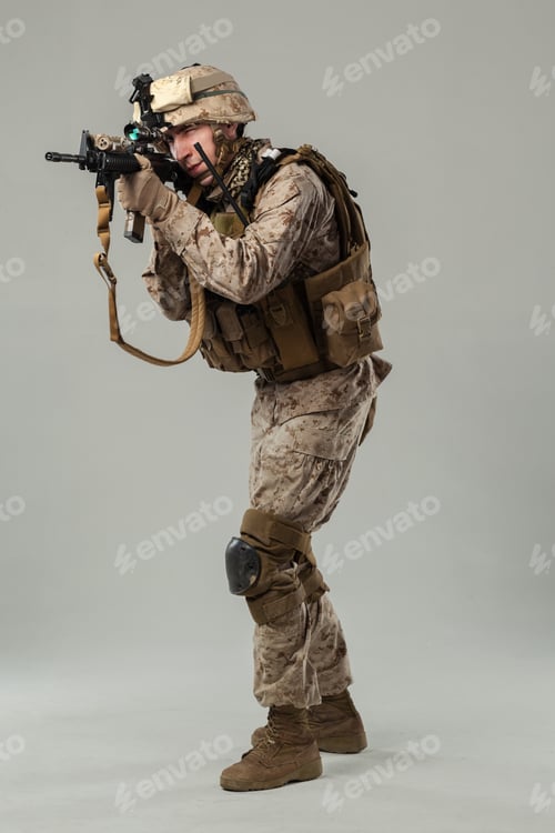 Preview: Soldier aims rifle while preparing for action in studio setting during daytime