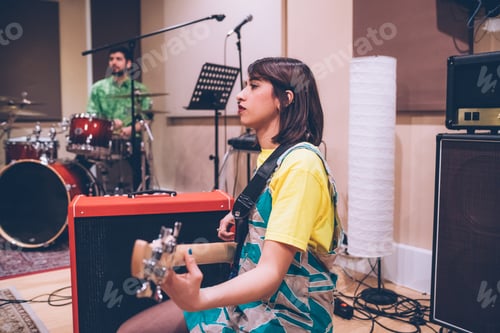 Preview: Young woman musician playing electric bass