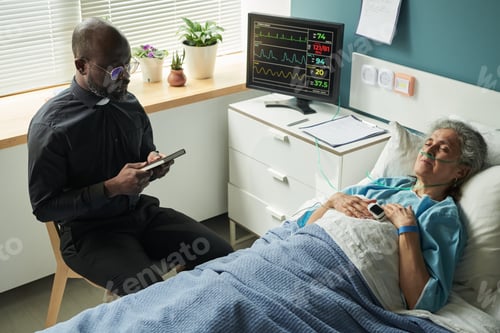 Preview: Chaplain Providing Spiritual Support to Senior Woman in Hospital