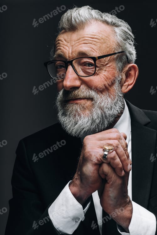 Preview: Pensive old business man in formal black suit, keeps palms near his chin