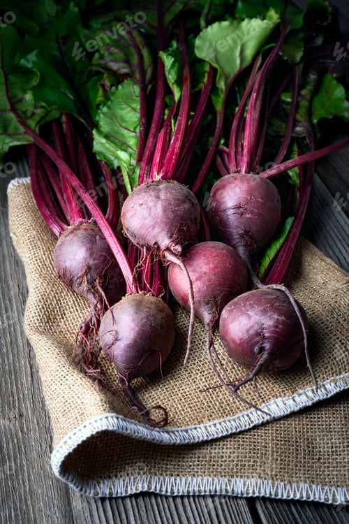 Preview: Bunch of fresh ripe beets with greens on a wooden table