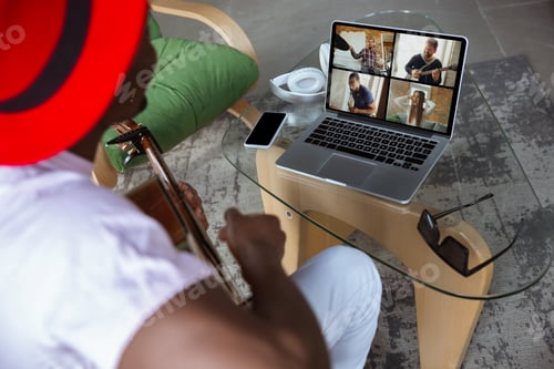 Preview: African-american musician playing guitar during concert at home isolated and quarantined, impressive