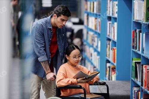 Preview: Asian girl with disability in library choosing books