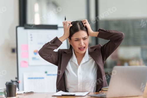 Preview: Stressed asian businesswoman with headache working at laptop in office.