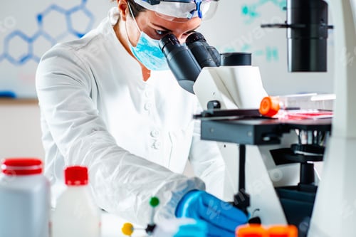 Researcher Works With Microscope in a Medical Lab