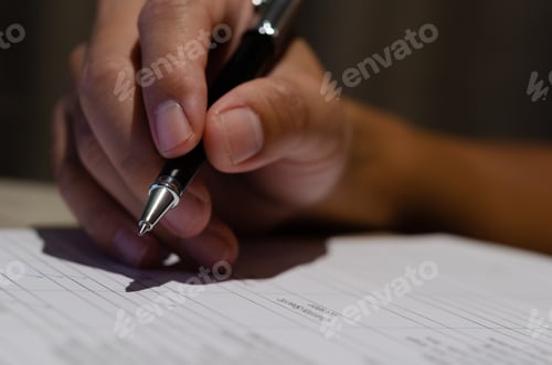 Preview: Businessman holding pen signature contract document finance investment or paperwork report on desk.