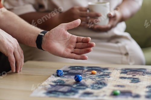 Preview: Senior Man Playing Board Game with Hand Throwing Dice on Table