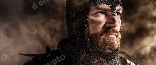 Preview: panoramic shot of handsome knight in armor looking away on black background