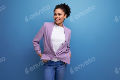 Preview: young well-groomed latin secretary woman with fluffy hair is dressed in a lilac jacket on a studio