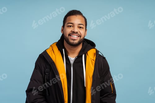 Preview: Portrait of positive happy man with braces looking at camera, wearing winter jacket