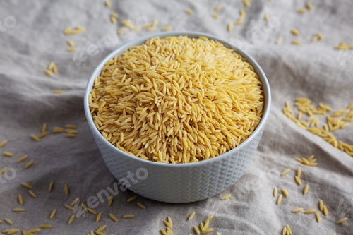 Preview: Raw Organic Risoni Pasta in a Bowl, side view.