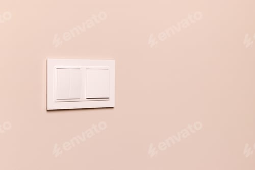 Preview: White electrical switches on beige wall