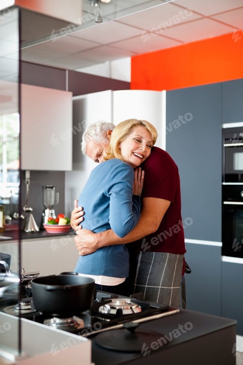 Preview: Senior Couple Hugging in Kitchen