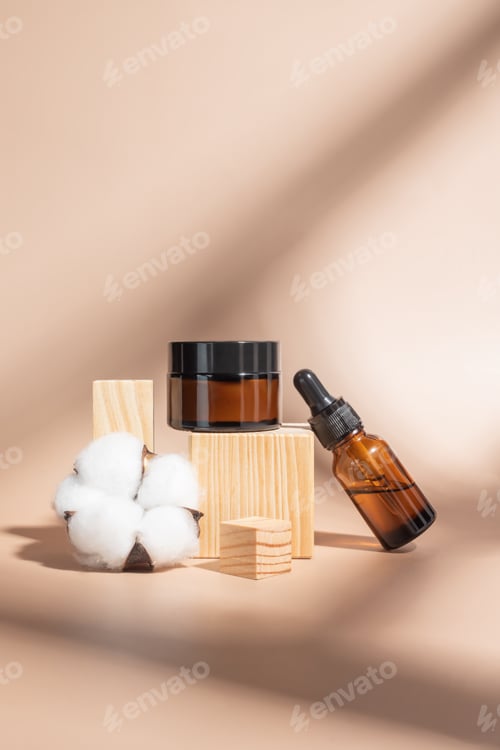 Preview: Cosmetics packaging. Set of different cosmetic jars and tubes of cream on woodn podiums. Blank