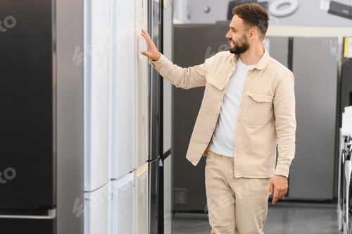 Preview: Customer choosing new refrigerator in electronics store