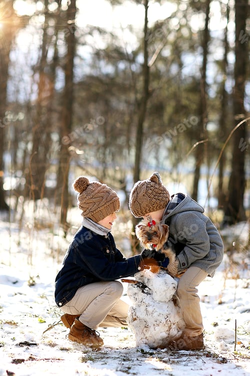 Preview: Sunny winter day.Boys sculpt a snowman with them dog