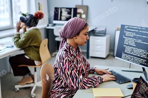 Preview: Muslim young woman as software developer writing code