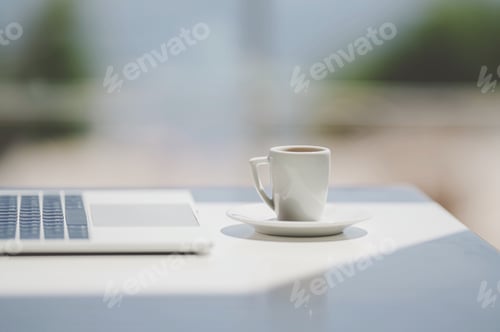 Preview: Side view laptop on natural light background white desk top with cup of coffee