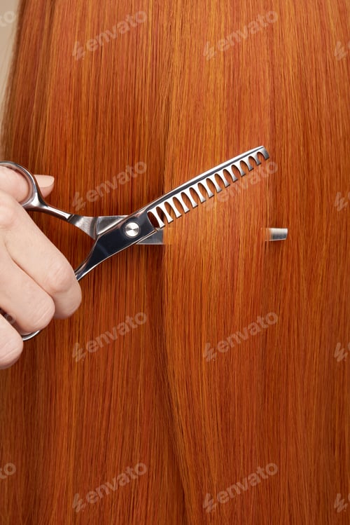 Preview: Hairdresser cuts long red hair with scissors
