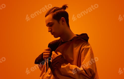 Preview: Trendy teen boy in studio with neon light