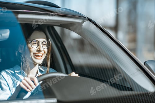 Preview: Happy woman driving a car