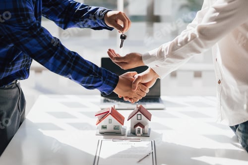 Preview: Real estate agents shake hands after the signing of the agreement is complete.