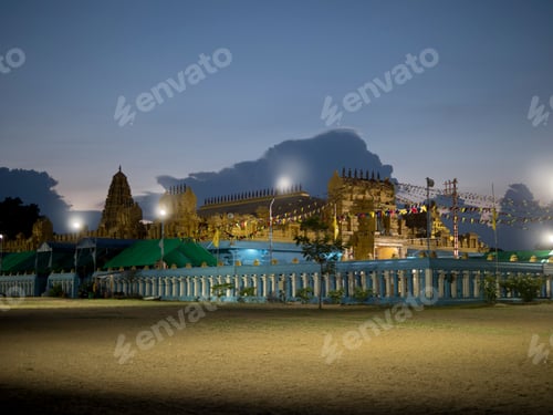 Preview: Evening falls over a festive outdoor gathering at a temple compound
