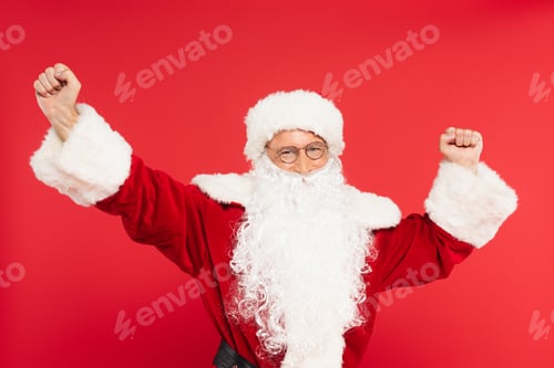 Preview: Santa claus in eyeglasses showing yes gesture isolated on red