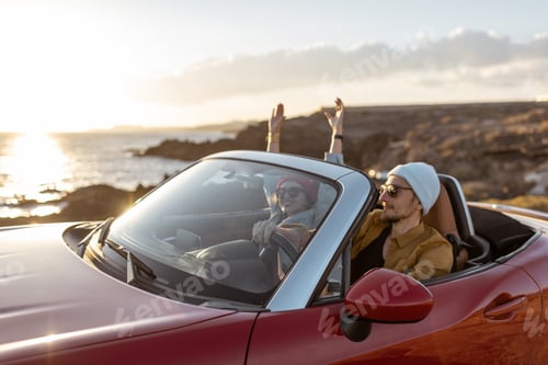 Preview: Lovely couple driving a cabriolet near the ocean