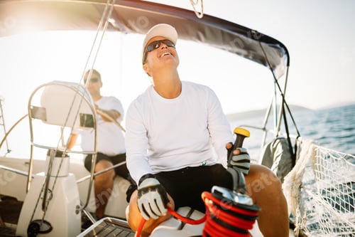 Preview: Attractive strong woman sailing with her boat