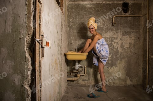 Preview: Cheap Accommodation. The Girl Washing Her Feet In The Sink