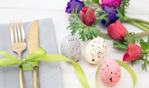 Preview: Easter table setting, Spring flowers and eggs decoration, napkin and golden cutlery on white wood