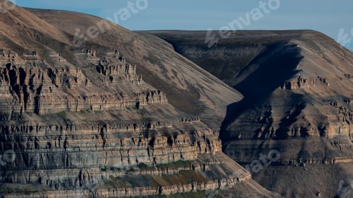Preview: Breathtaking Svalbard landscape showcasing rugged mountains under clear blue skies