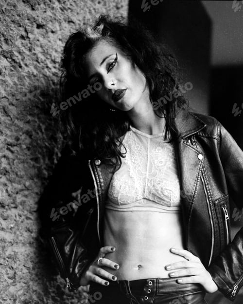 Preview: Young rock musician posing with leather jacket and lace top in monochrome analog film photography