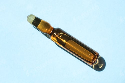Preview: Ampoule of cosmetic gel on a blue background.