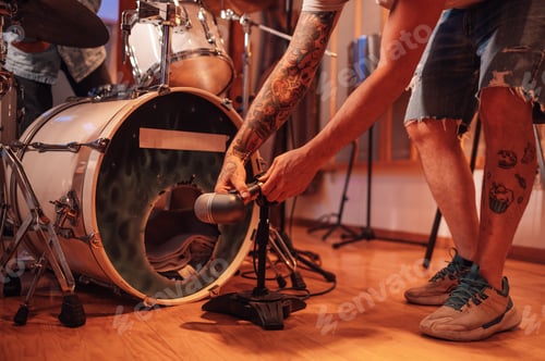 Preview: Close up sound engineer adjusting microphone for drums recording in studio