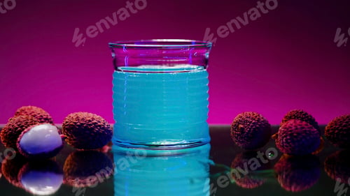 Preview: Refreshing non alcoholic beverage of blue color isolated on pink lighted wall background. Stock clip