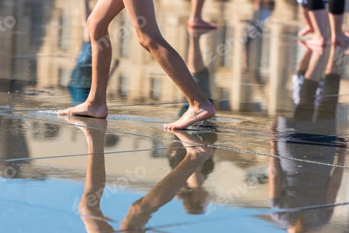 Preview: People having fun in a mirror fountain in Bordeaux, France