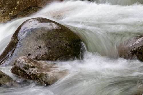 Preview: Flowing water around the soft rocks. Nature Background
