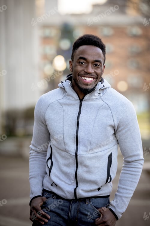 Preview: Vertical shot of an attractive African American male smiling at the camera