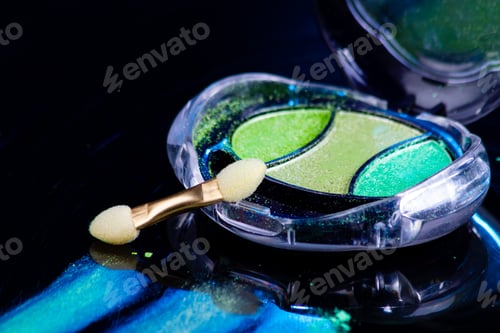 Preview: Close up of colorful eye shadow palette and brush.