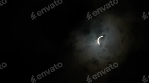 Preview: Solar eclipse with the moon shining through dark clouds in Waco, Texas