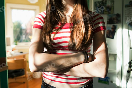 Preview: Teenage girl with arms crossed