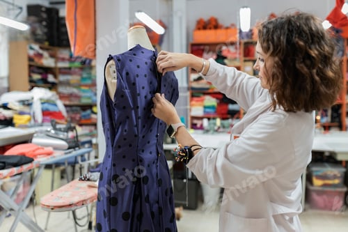 Preview: Woman wearing cloth on mannequin in shop