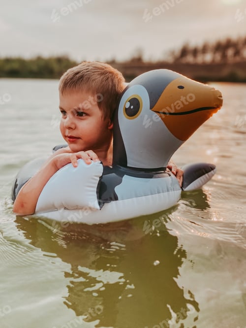 Preview: Little boy swimming in a lake