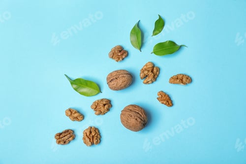 Preview: Flat lay composition with tasty walnuts on color background