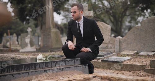 Preview: Funeral, cemetery and man with flower at tombstone for remembrance, burial ceremony and memorial se