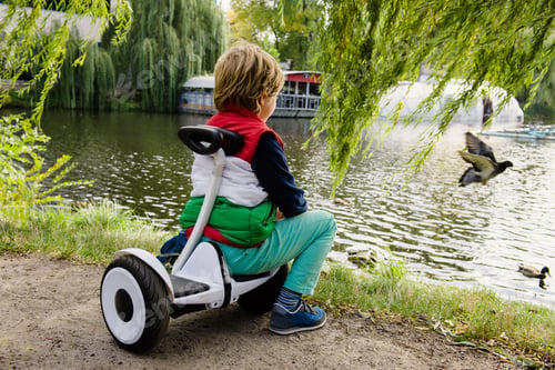 Preview: Boy on his new electronic hoverboard in the city outdoors